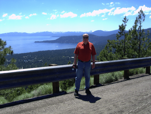 Thomas standing on the side of the road in front of an American landscape panorama