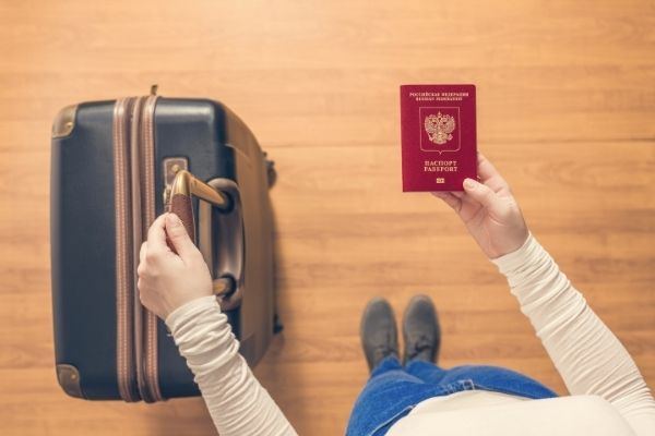 Person with a suitcase and their passport ready to travel to the USA