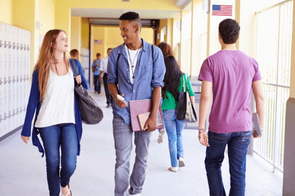 Students walking down the hallways of a high school together