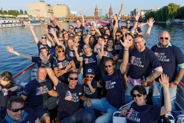 Green card winners wave at camera